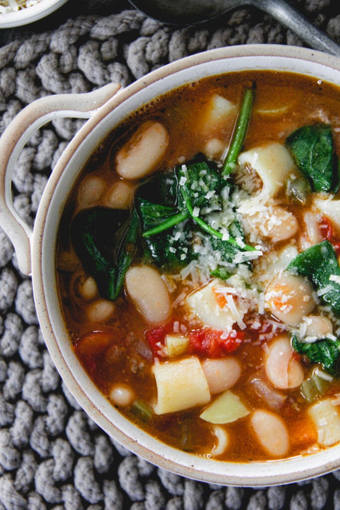 top down close up of a bowl of tomato white bean hamburger soup