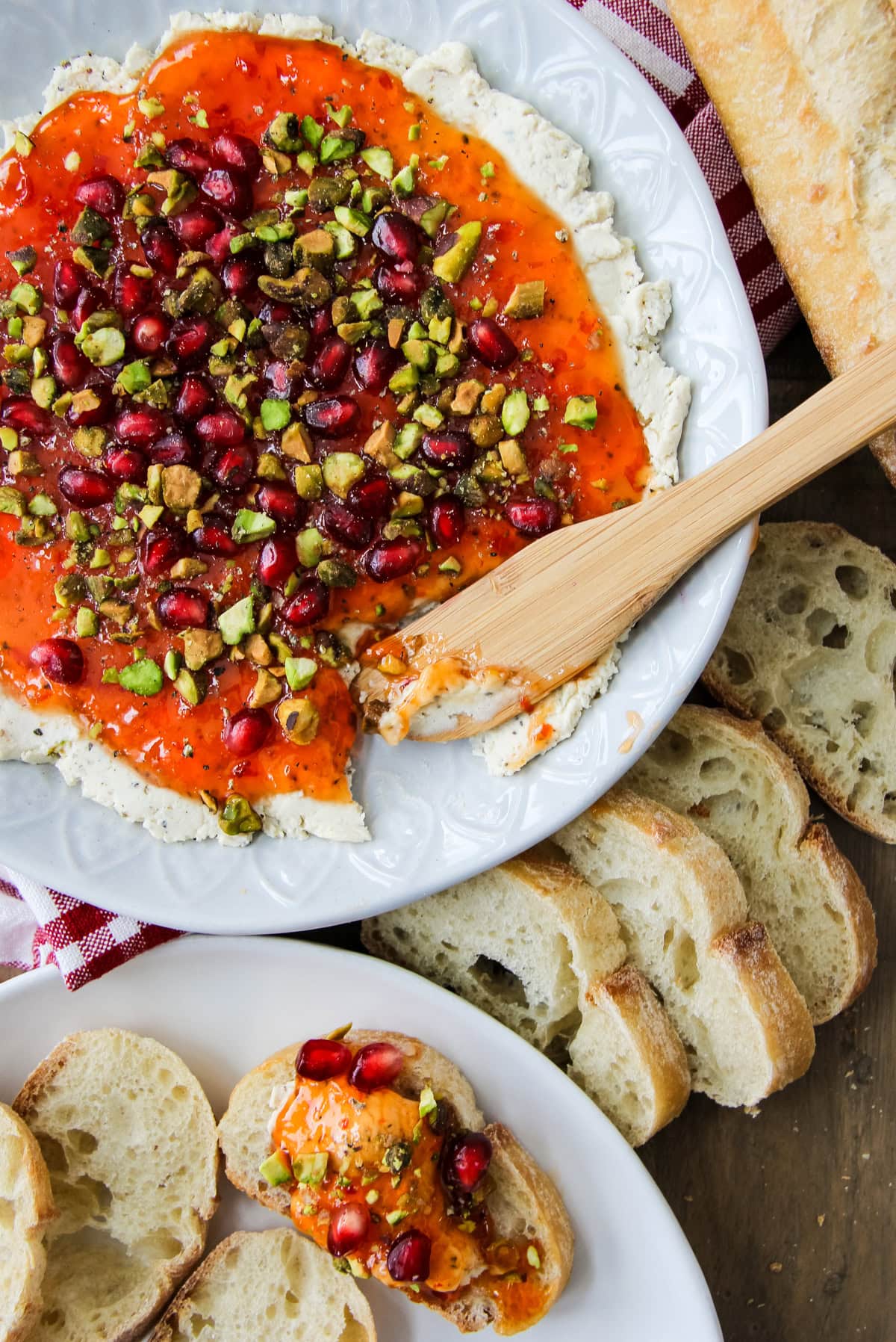 a bowl of Festive Red Pepper Jelly Boursin Dip next to baguette slices