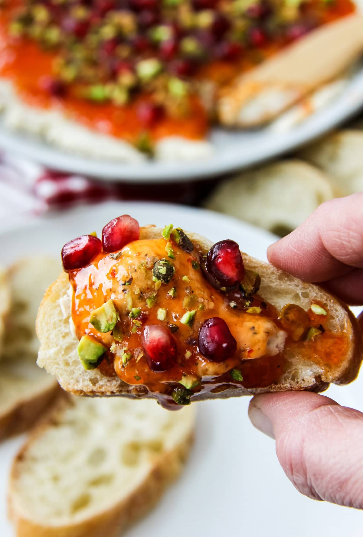 a baguette slice topped with Festive Red Pepper Jelly Boursin Dip