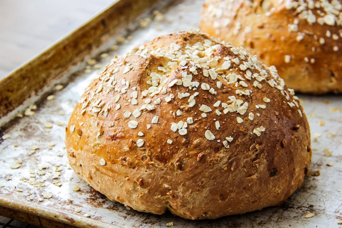 loaves of Hearty Bread Machine Honey Oat Bread on a baking pan