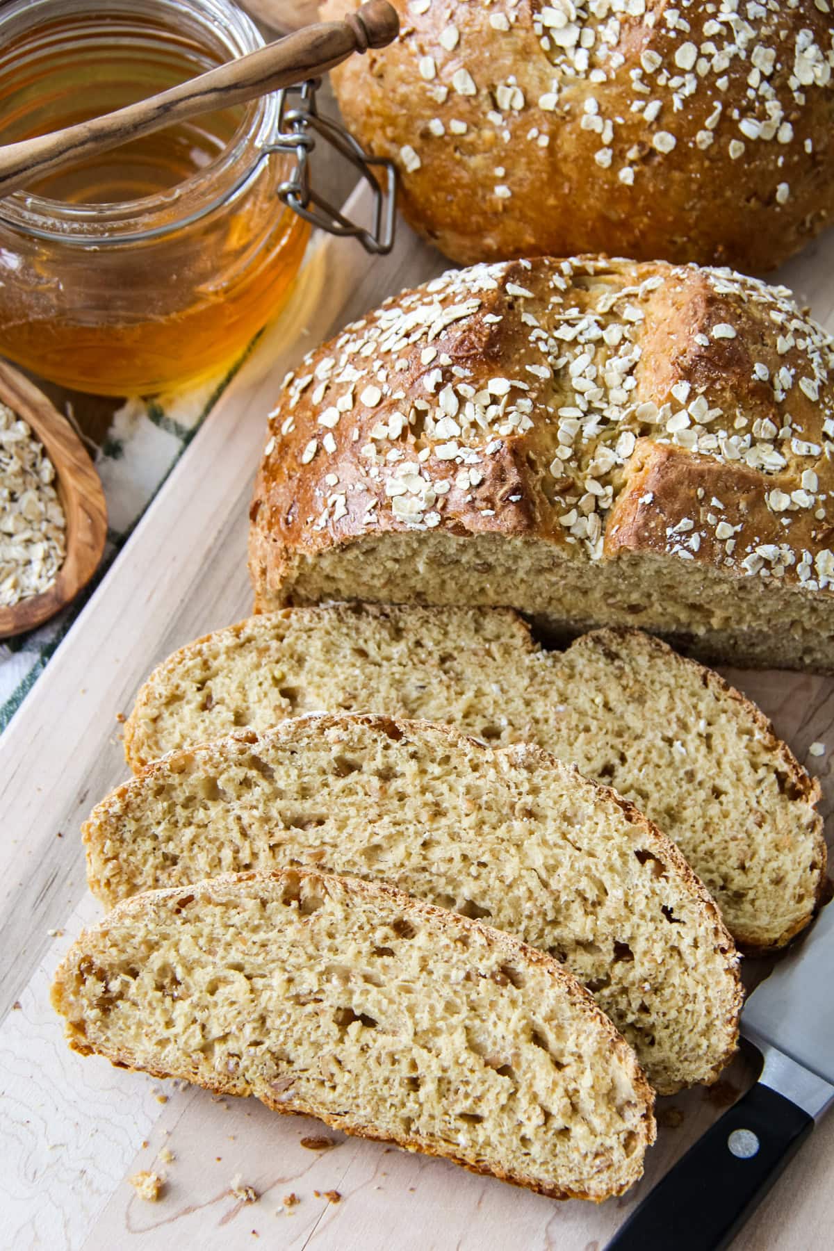 a loaf of Hearty Bread Machine Honey Oat Bread cut into slices