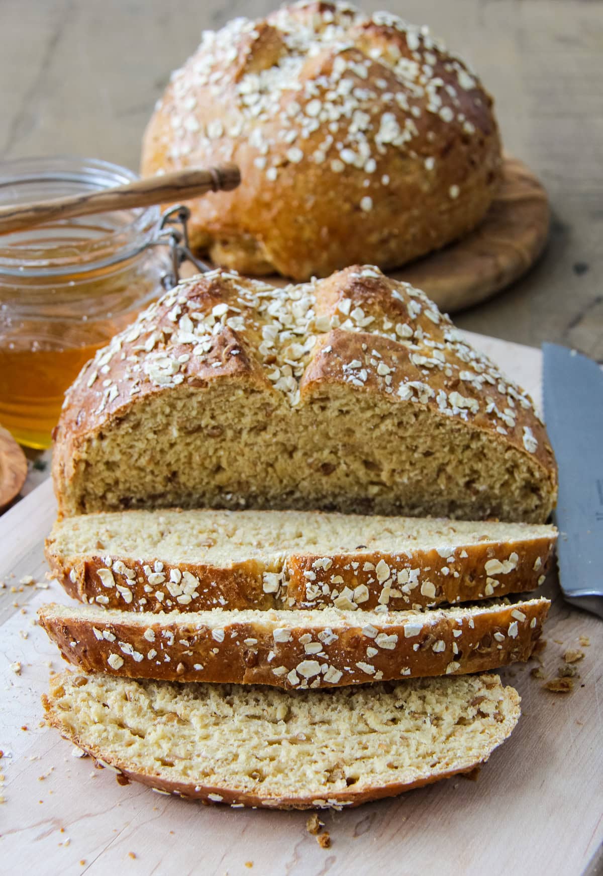 a loaf of Hearty Bread Machine Honey Oat Bread cut into slices