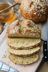 a loaf of Hearty Bread Machine Honey Oat Bread cut into slices