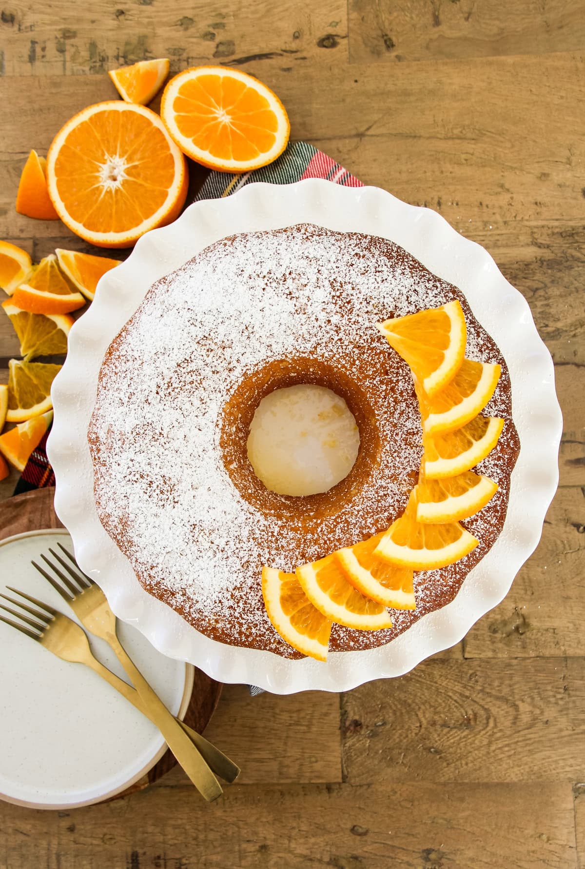 an orange bundt cake on a white cake stand