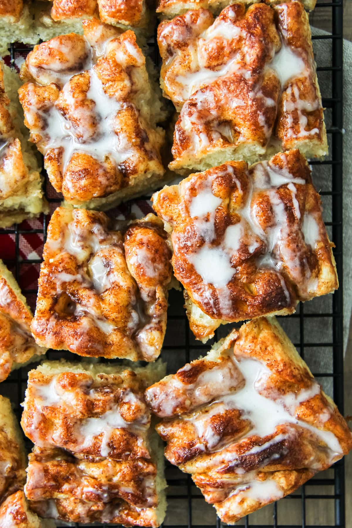 squares of cinnamon roll focaccia on a wire cooling rack