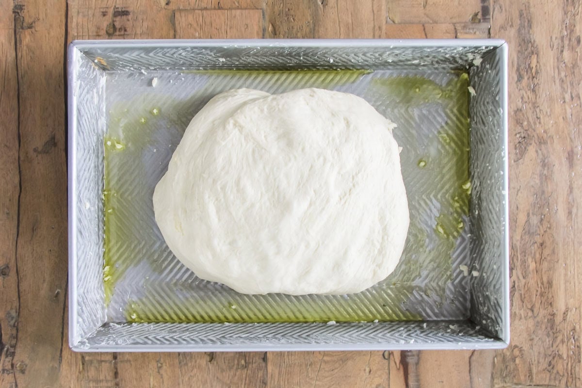 a ball of dough in a baking pan