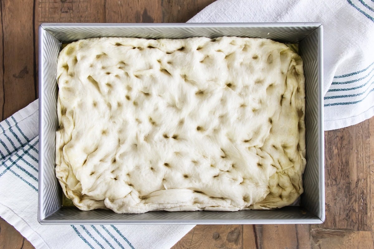 cinnamon roll focaccia dough in a baking pan