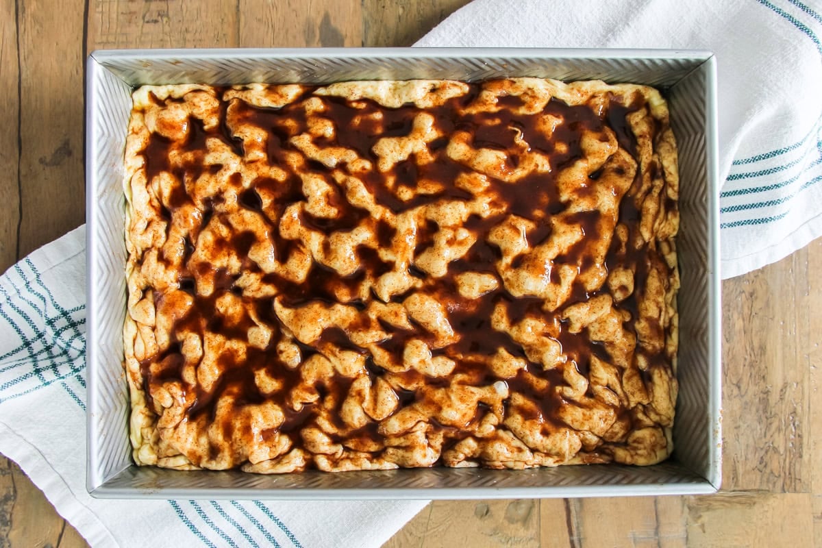 unbaked cinnamon roll focaccia in a baking pan