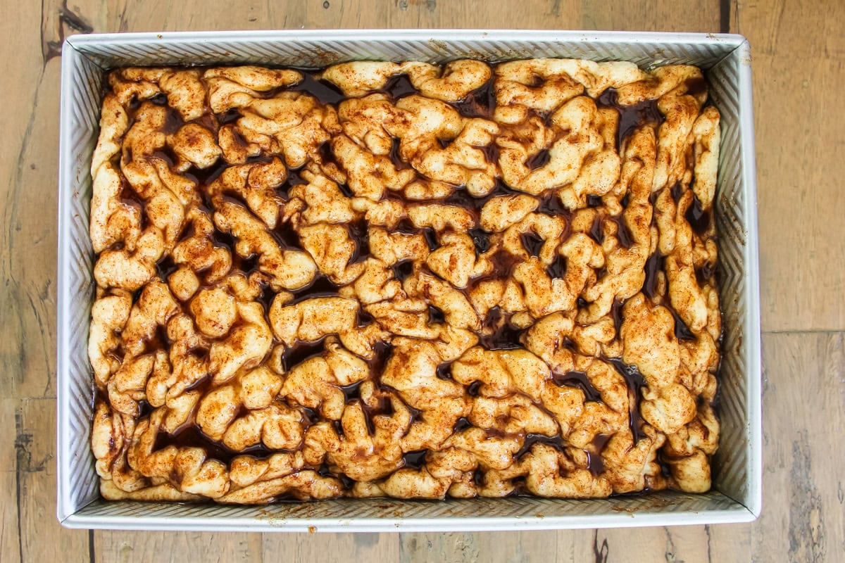 unbaked cinnamon roll focaccia in a baking pan