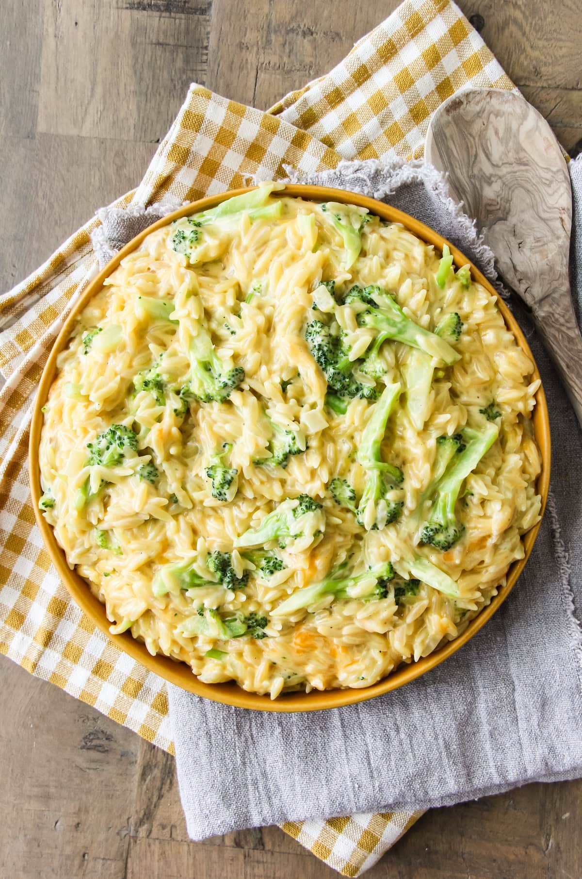 One Pot Cheesy Broccoli Cheddar Orzo in a yellow bowl
