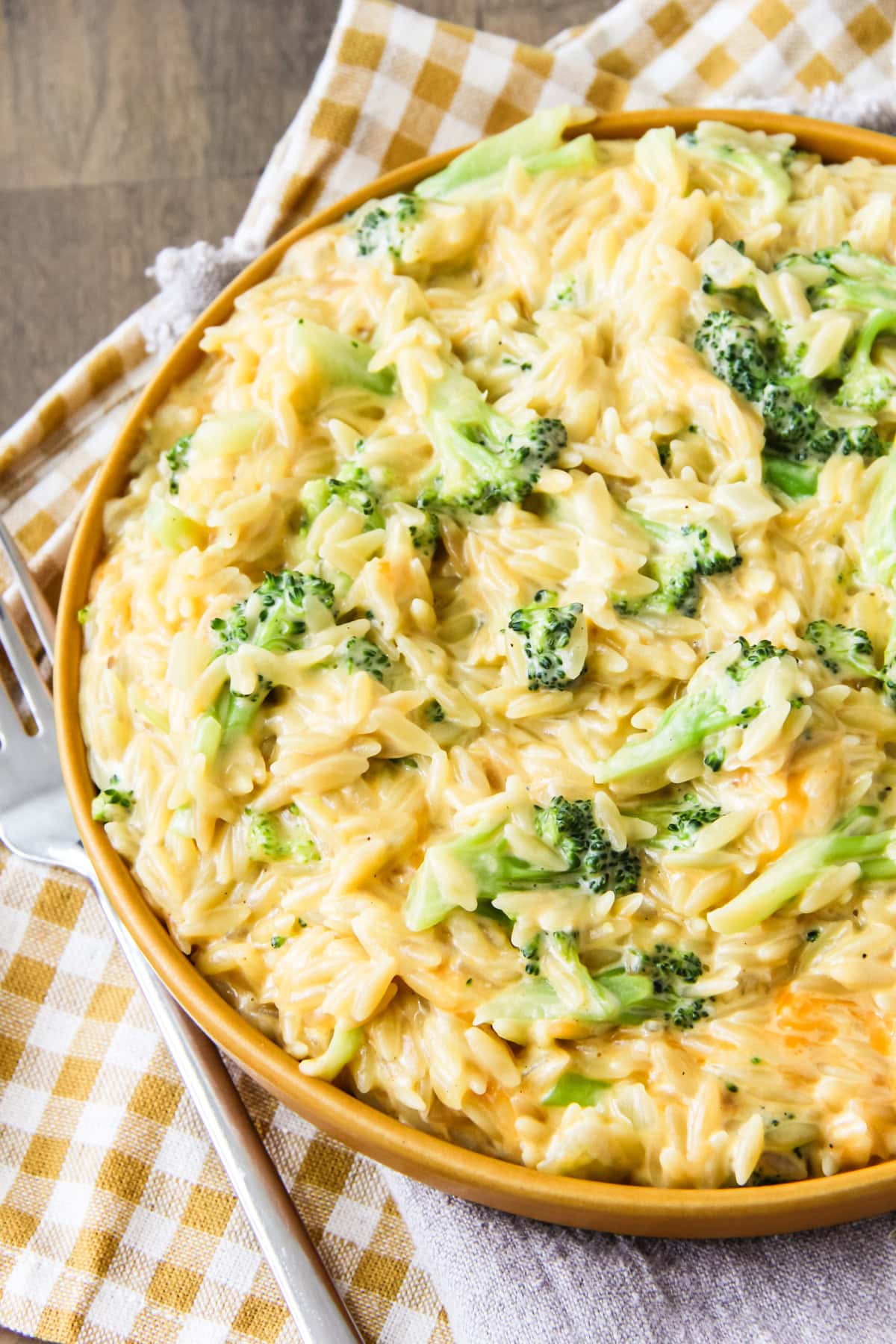 One Pot Cheesy Broccoli Cheddar Orzo in a yellow bowl
