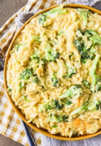 One Pot Cheesy Broccoli Cheddar Orzo in a yellow bowl