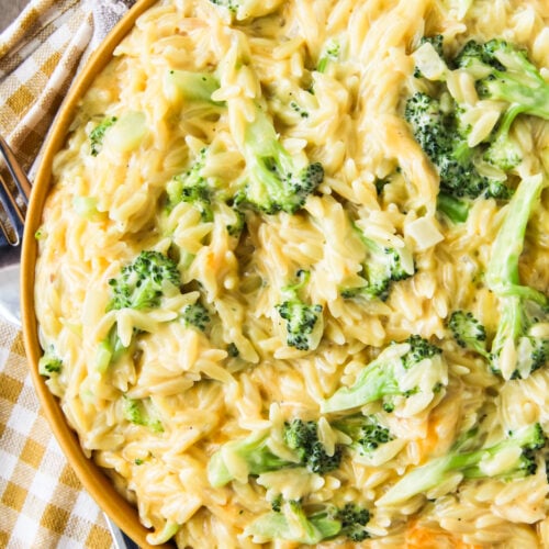 One Pot Cheesy Broccoli Cheddar Orzo in a yellow bowl