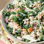 a bowl of Kale and White Bean Salad on a wood table
