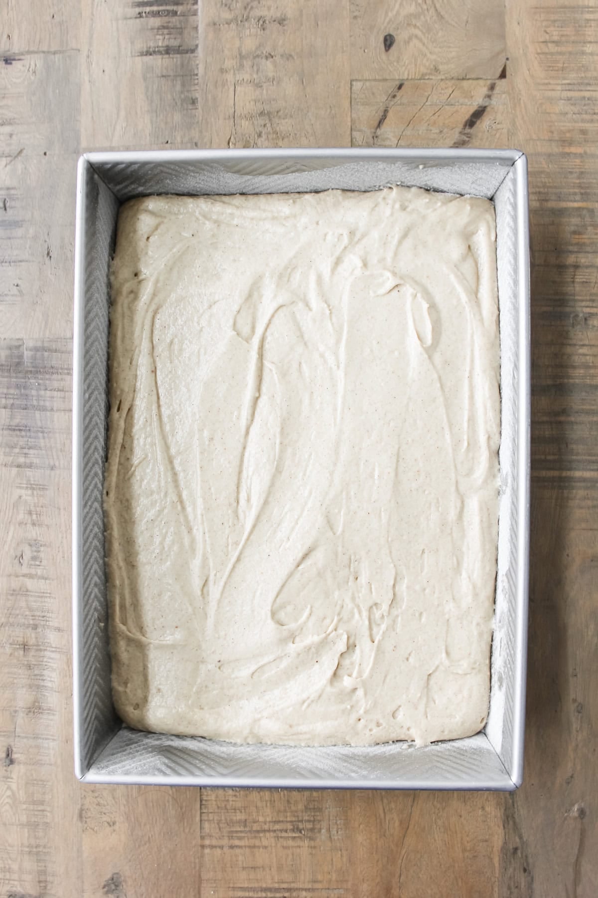 top down image a baking pan of spice cake batter