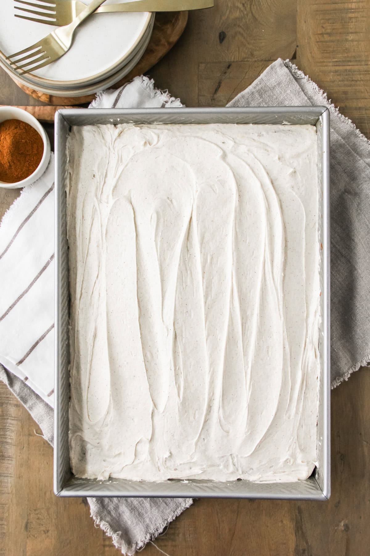 top down image a baking pan of frosted spice cake