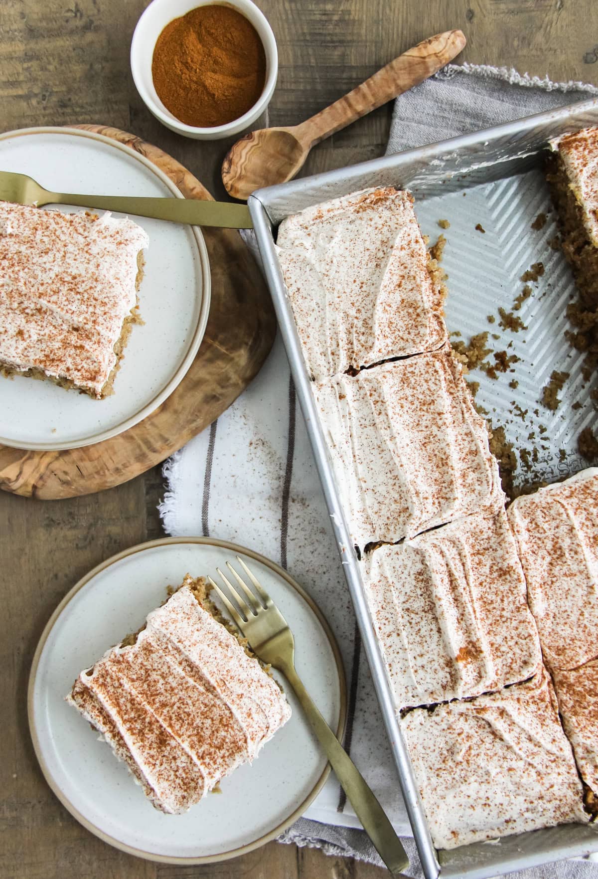 top down image of a two squares of spice cake on a plate next to the baking pan