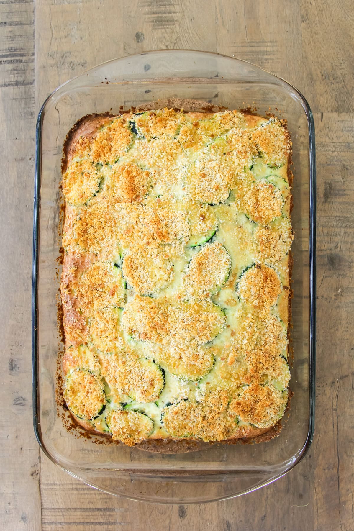 a top down image of a baking pan of crustless zucchini pie