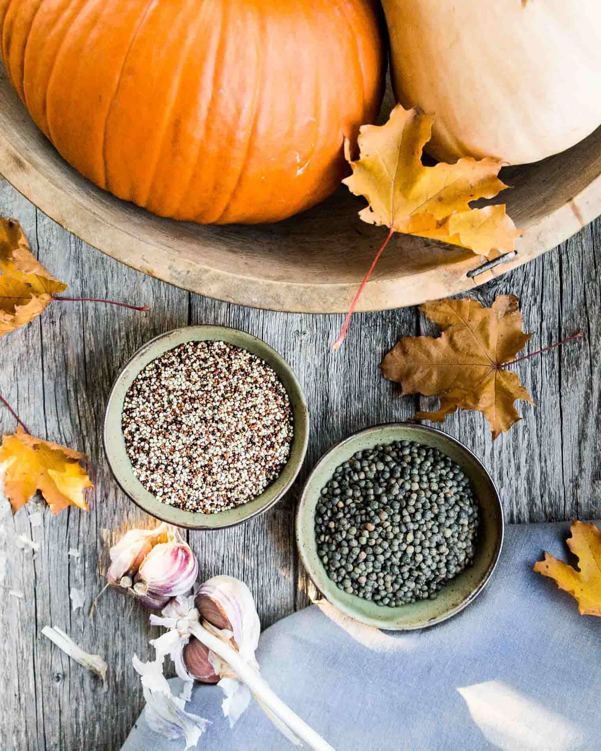 a top down image of two bowls of spices and a bowl of pumpkins and squash